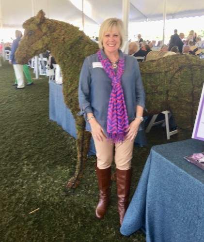 Eileen standing in front of a horse made of grass