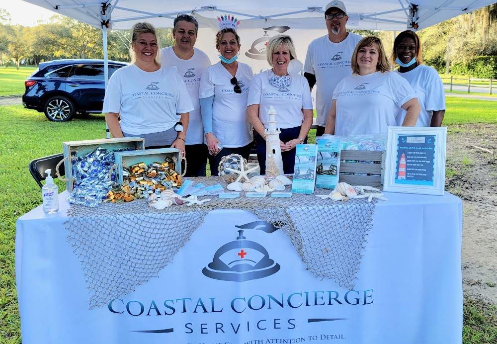 Team members standing behind a display table